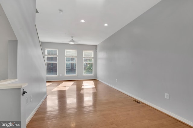 unfurnished living room with ceiling fan and light hardwood / wood-style floors