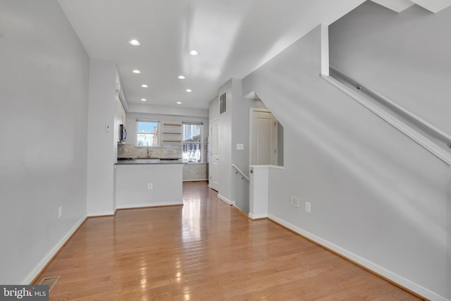 unfurnished living room with light hardwood / wood-style floors