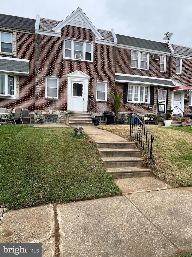 view of property featuring a front lawn