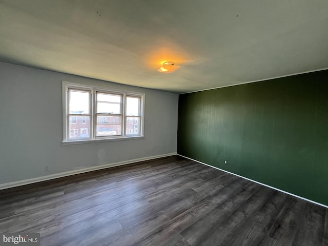 unfurnished room featuring dark hardwood / wood-style floors