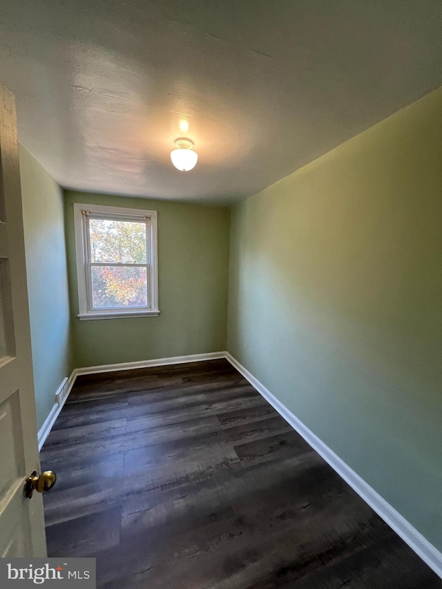 empty room featuring dark hardwood / wood-style floors