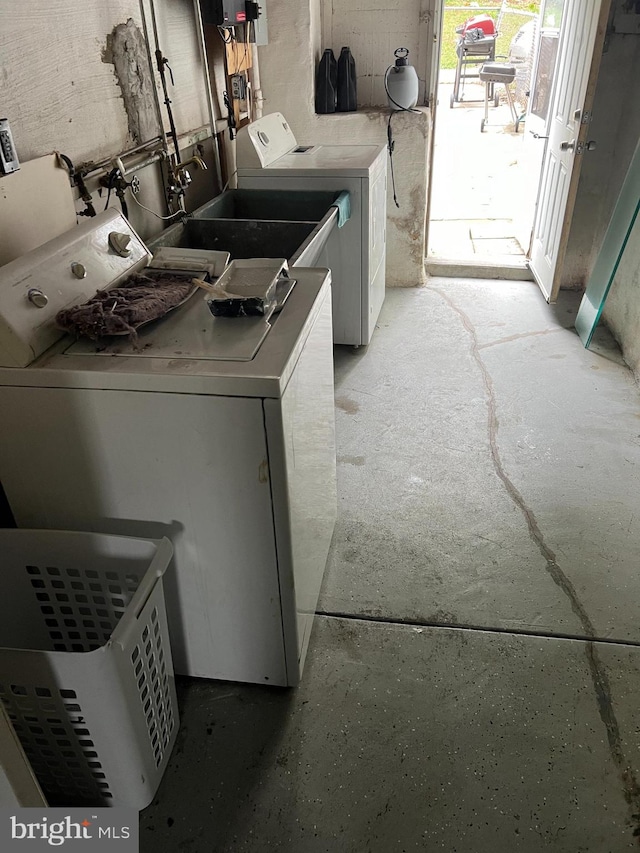 clothes washing area with washer and dryer and sink