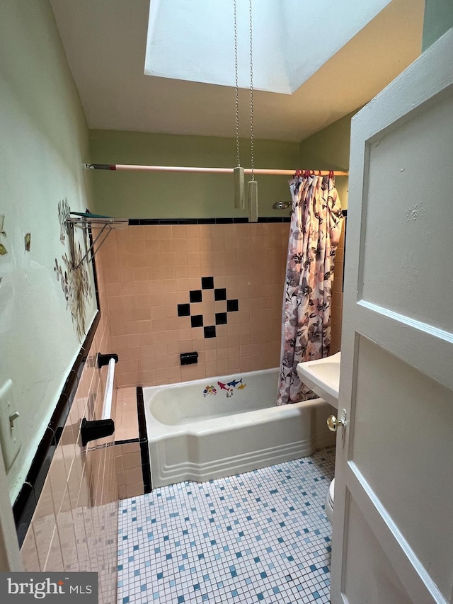 bathroom featuring tile patterned flooring, toilet, tile walls, and shower / tub combo