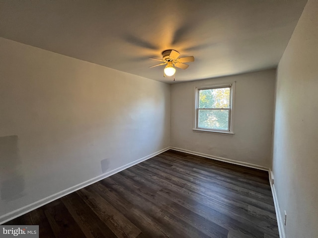 spare room with dark hardwood / wood-style floors and ceiling fan