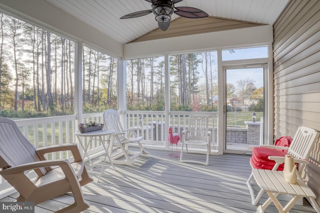 sunroom featuring ceiling fan, lofted ceiling, and wooden ceiling