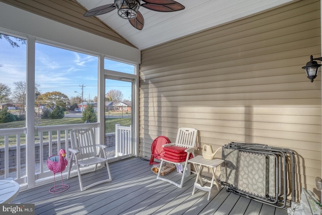 sunroom / solarium with ceiling fan and vaulted ceiling