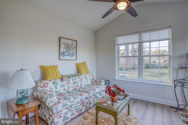 living room with hardwood / wood-style floors, ceiling fan, and lofted ceiling