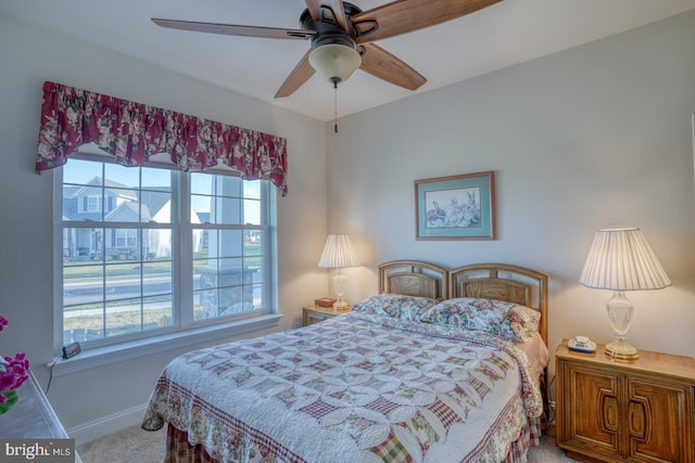 bedroom featuring multiple windows, ceiling fan, and carpet floors