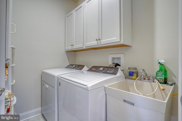 washroom with separate washer and dryer, sink, light tile patterned flooring, and cabinets