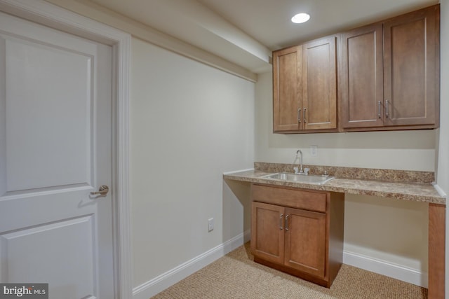 102 Serenity Cir, Middletown, DE 19709 - kitchen with a sink, light countertops, brown cabinetry, recessed lighting, and baseboards