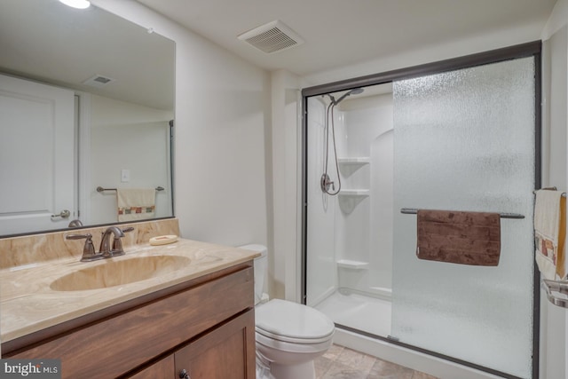 bathroom featuring toilet, vanity, and walk in shower