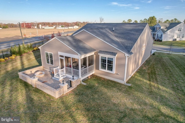 102 Serenity Cir, Middletown, DE 19709 - back of house featuring a shingled roof and an outdoor fire pit