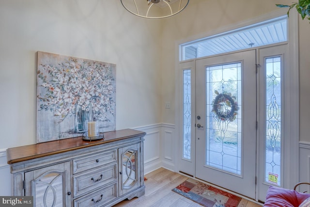 102 Serenity Cir, Middletown, DE 19709 - foyer entrance with light wood-type flooring, a decorative wall, and a wainscoted wall