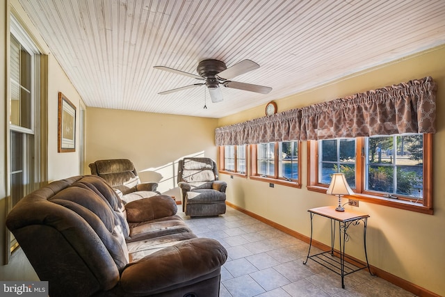 living room featuring ceiling fan and light tile patterned flooring