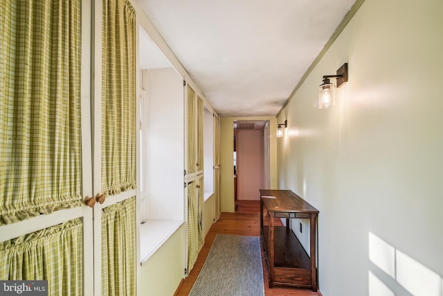 corridor with wood-type flooring