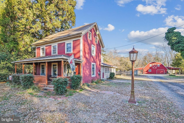 4555 Snow Hill Rd, Salisbury, MD 21804 - view of front of property with a porch, an outdoor structure, and a barn