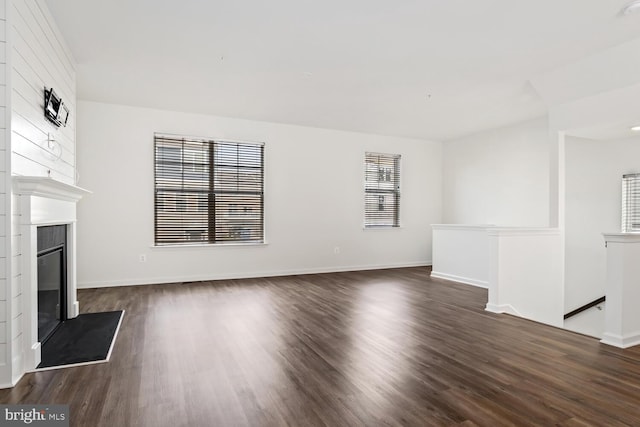 unfurnished living room featuring dark hardwood / wood-style floors