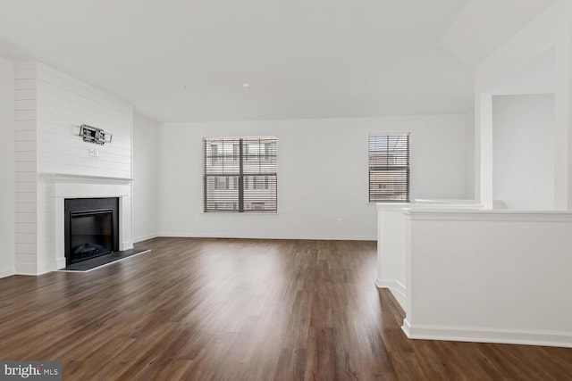 unfurnished living room featuring dark hardwood / wood-style flooring