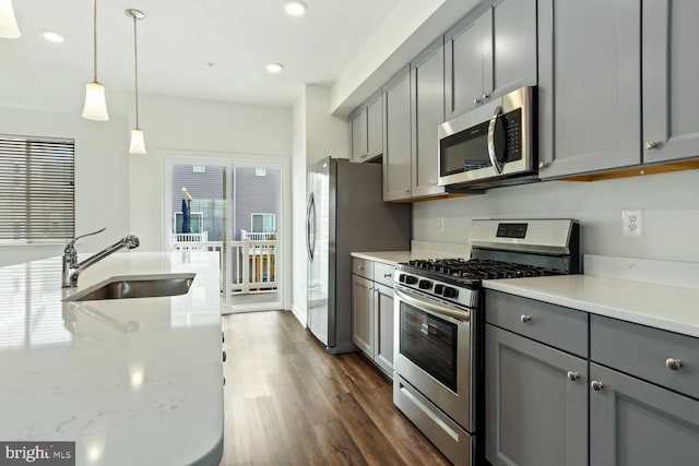 kitchen featuring appliances with stainless steel finishes, gray cabinets, plenty of natural light, and sink