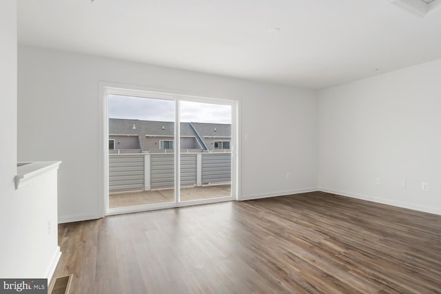 spare room featuring wood-type flooring