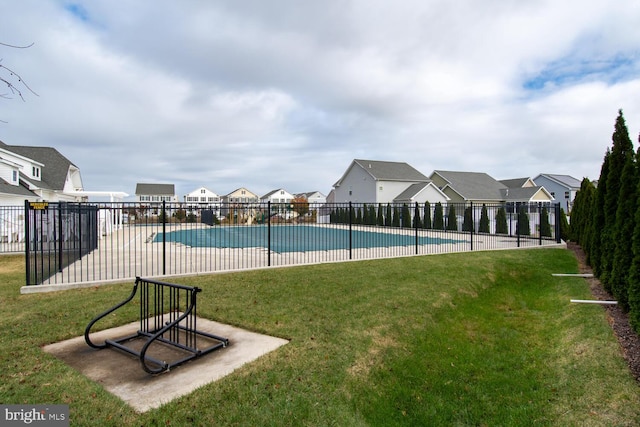 view of swimming pool featuring a lawn