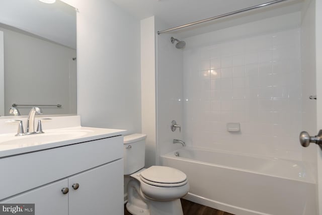 full bathroom featuring washtub / shower combination, vanity, hardwood / wood-style flooring, and toilet