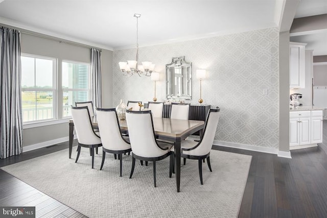 dining room with a chandelier, crown molding, and dark wood-type flooring