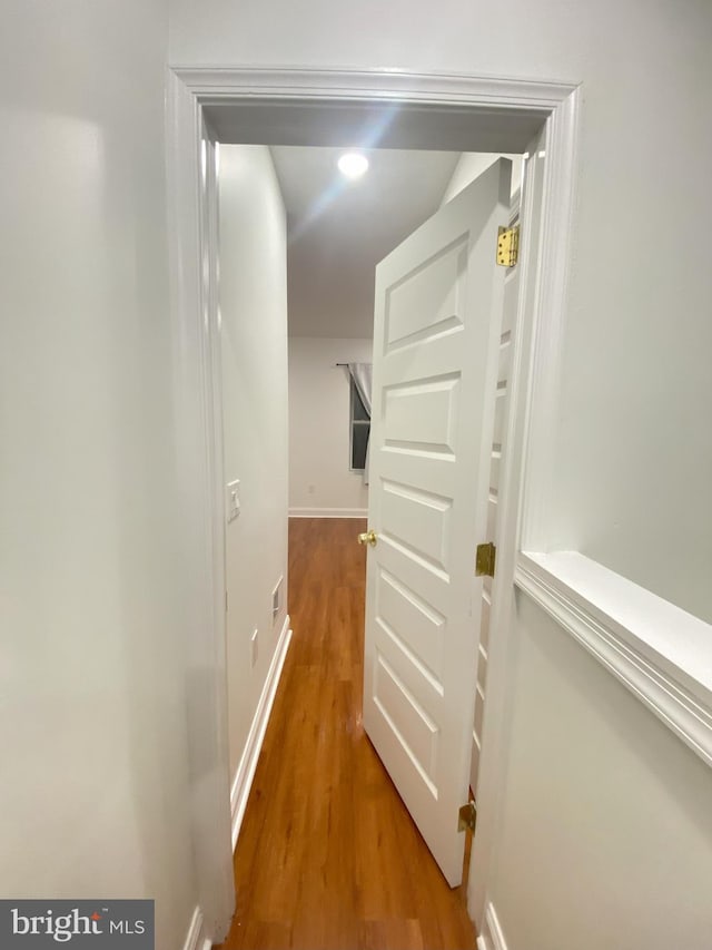 corridor with hardwood / wood-style floors