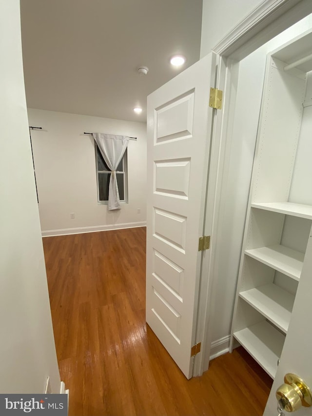 hallway with wood-type flooring