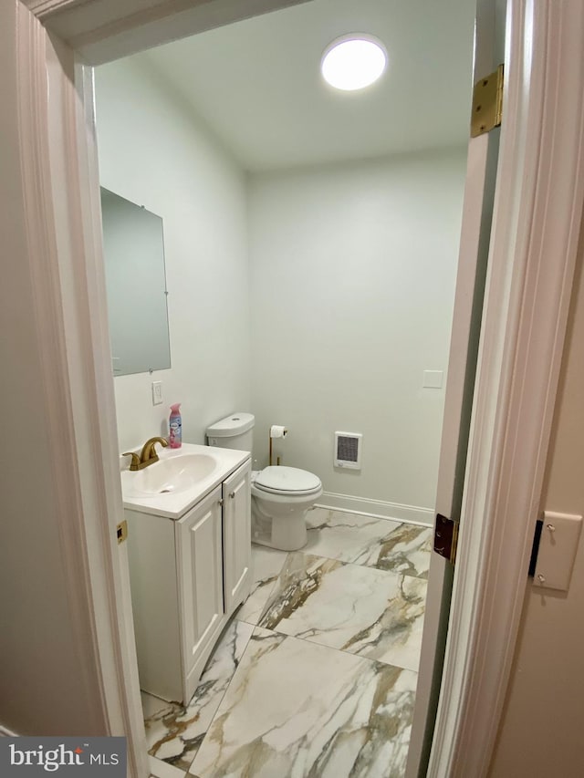 bathroom featuring vanity and toilet