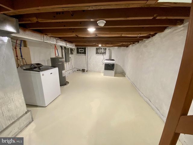 basement featuring washer / dryer and electric water heater