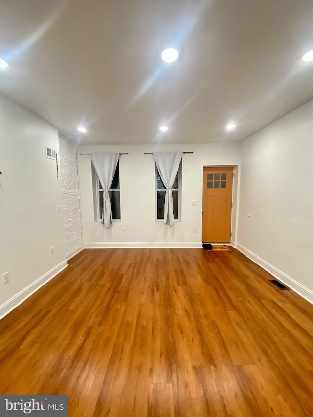 spare room with hardwood / wood-style floors