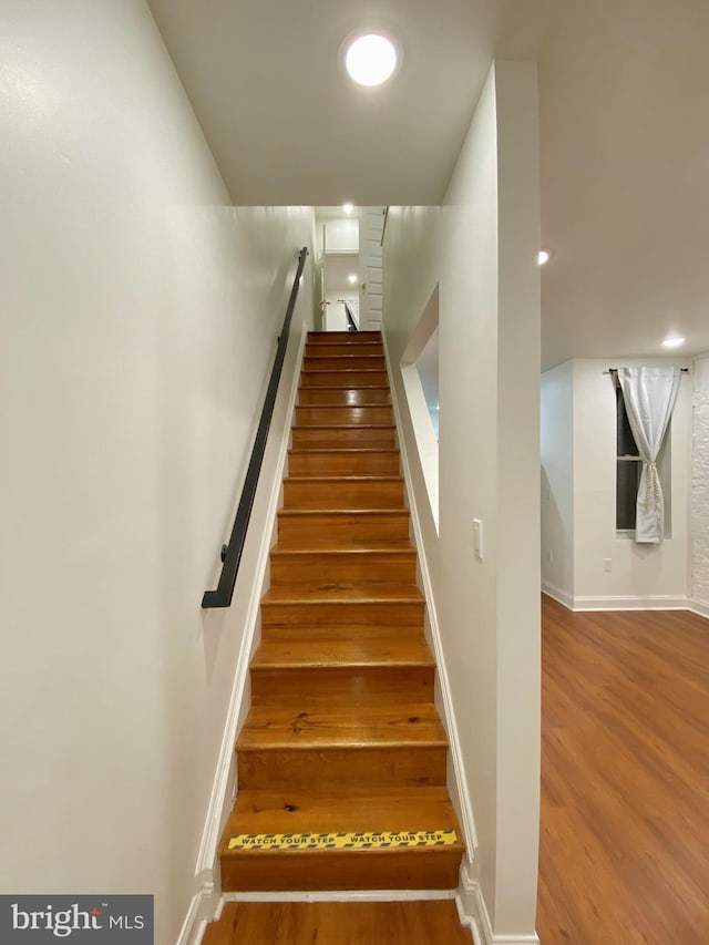 stairway with wood-type flooring