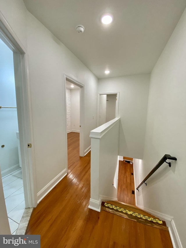 hall with hardwood / wood-style flooring