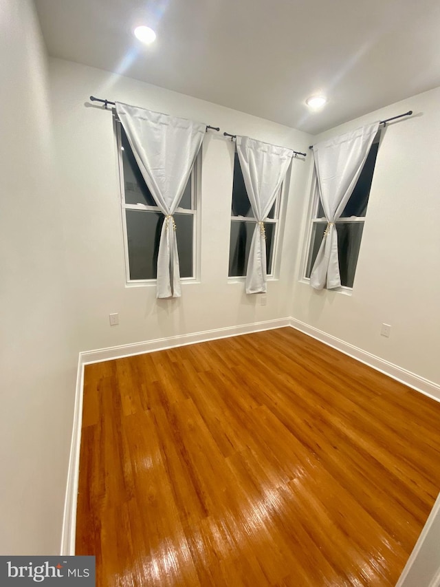 unfurnished room featuring hardwood / wood-style floors