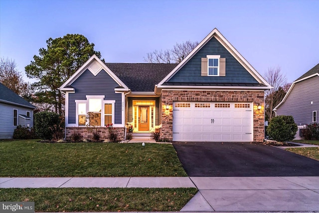 craftsman-style home with a lawn and a garage