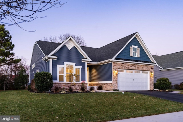 craftsman-style home with a yard and a garage