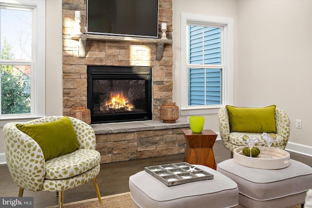 sitting room featuring a fireplace, plenty of natural light, and wood-type flooring