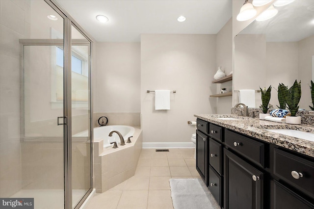 full bathroom with plus walk in shower, vanity, tile patterned floors, and toilet