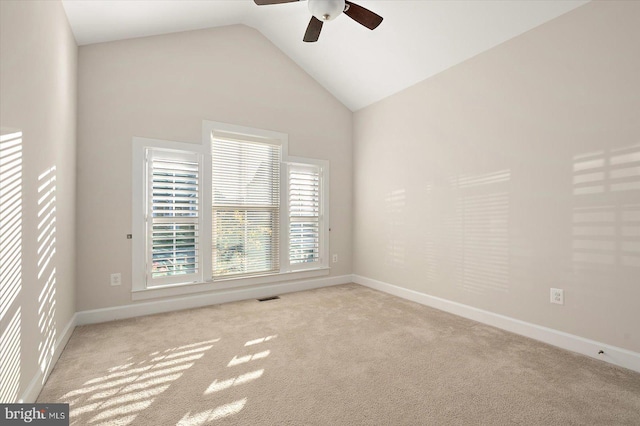 spare room featuring ceiling fan, high vaulted ceiling, and light colored carpet