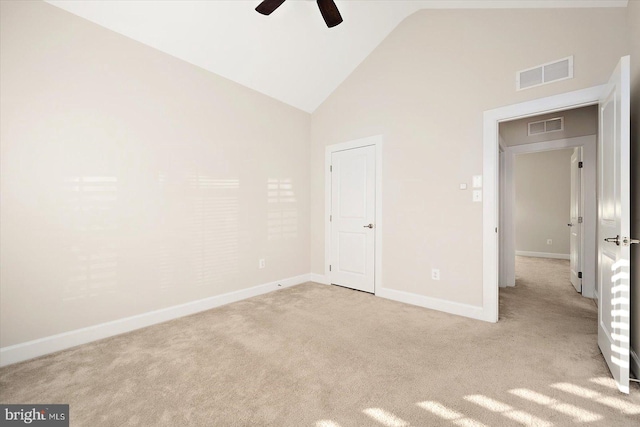 unfurnished bedroom with light carpet, high vaulted ceiling, and ceiling fan