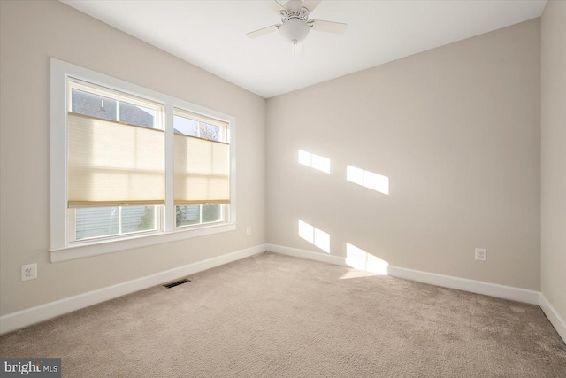 carpeted empty room featuring ceiling fan