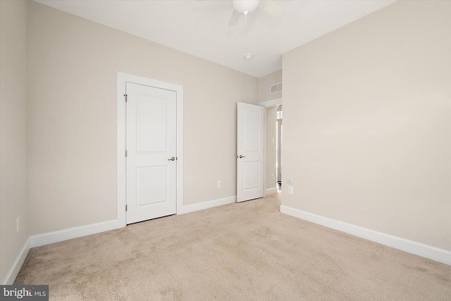 unfurnished bedroom featuring ceiling fan and light colored carpet