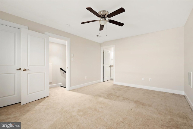 unfurnished bedroom featuring ceiling fan and light carpet