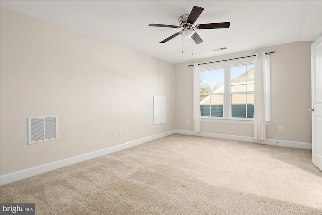 spare room with light colored carpet and ceiling fan