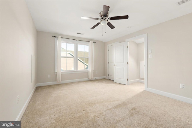 unfurnished bedroom featuring light colored carpet and ceiling fan