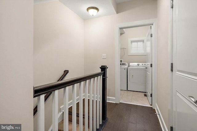 laundry room with washer and dryer and light hardwood / wood-style flooring