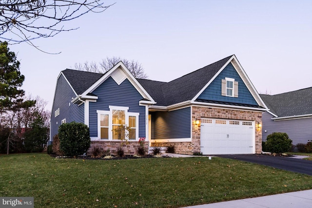 craftsman inspired home with a yard and a garage