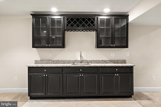 bar featuring light carpet and sink