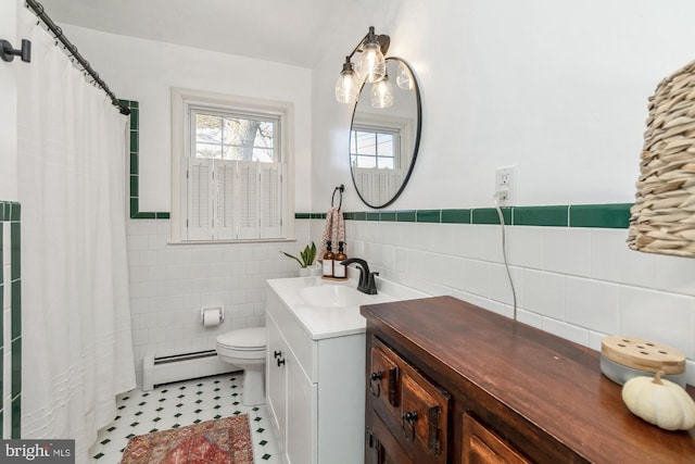 bathroom featuring a baseboard radiator, tile patterned flooring, toilet, vanity, and tile walls